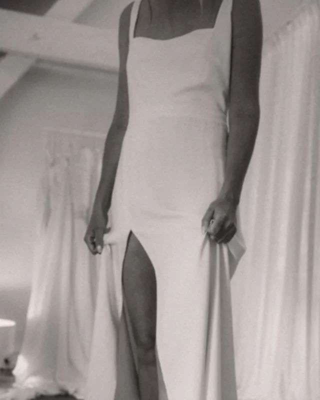 FAYE ➕ A silk wedding dress featuring a timeless square neckline and a soft skirt slit, blending classic elegance with a modern, effortless feel. Perfect for the bride who loves simplicity with a subtle statement. . . #themewsloves