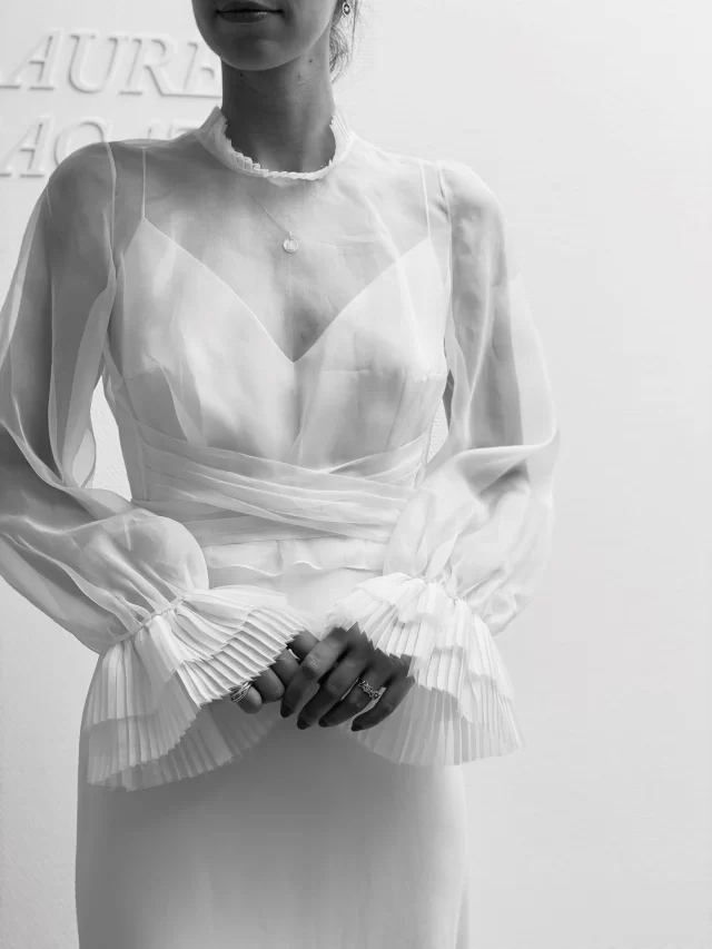 DETAILS ➕ The gorgeous Portimao top by @lauredesagazan features long pleated sleeves, a high pleated collar, and a draped tie belt. It is perfect for adding versatile, high-fashion volume to a minimalistic wedding gown . . . J'adore #themewsloves